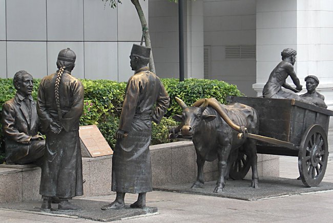 three Singapore River merchant statue
