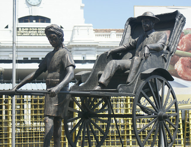 Statue of a colonial planter in a rickshaw